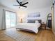 Inviting bedroom with a modern ceiling fan, a slider to the pool and wood floors at 6835 E Friess Dr, Scottsdale, AZ 85254
