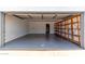 Clean, well-lit garage with epoxy floors and built-in shelving offers ample storage space at 6835 E Friess Dr, Scottsdale, AZ 85254