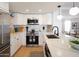 Modern kitchen with white cabinets, stainless steel appliances, and quartz countertops at 6835 E Friess Dr, Scottsdale, AZ 85254