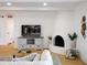 Cozy living room features a white fireplace, wood floors, and a comfortable seating area at 6835 E Friess Dr, Scottsdale, AZ 85254