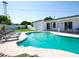 Inviting pool surrounded by lounge chairs, lush greenery and a covered patio create a serene outdoor oasis at 6835 E Friess Dr, Scottsdale, AZ 85254