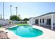 Inviting pool surrounded by lounge chairs, lush greenery and a covered patio create a serene outdoor oasis at 6835 E Friess Dr, Scottsdale, AZ 85254