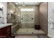 Stunning bathroom featuring a glass-enclosed shower with unique tile and a modern vanity with dual sinks at 6862 W Honeysuckle Dr, Peoria, AZ 85383