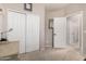 A neutral bedroom features carpeted floors, white closet doors, and an open doorway to another room at 6862 W Honeysuckle Dr, Peoria, AZ 85383