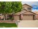 Charming two-story home with a well-manicured lawn, mature tree and a three car garage at 6862 W Honeysuckle Dr, Peoria, AZ 85383
