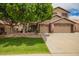 Charming two-story home with a well-manicured lawn, mature tree and a three car garage at 6862 W Honeysuckle Dr, Peoria, AZ 85383
