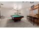 A game room features a pool table, bar with stools, recessed lighting and windows with blinds at 6862 W Honeysuckle Dr, Peoria, AZ 85383