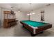 This game room features a pool table, bar, with stools, and recessed lighting at 6862 W Honeysuckle Dr, Peoria, AZ 85383