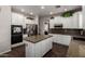 Spacious kitchen featuring stainless steel appliances, a center island, and hardwood flooring at 6862 W Honeysuckle Dr, Peoria, AZ 85383