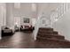 Bright living room showcasing tall ceilings, dark wood flooring and a staircase at 6862 W Honeysuckle Dr, Peoria, AZ 85383
