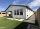 This backyard features artificial grass and a concrete patio at 6947 W Spur Dr, Peoria, AZ 85383