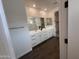 Spacious bathroom with double vanity, white cabinetry, and views of the walk-in shower at 6947 W Spur Dr, Peoria, AZ 85383