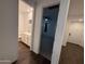 Bathroom with a white vanity, leading to a bedroom featuring a ceiling fan and soft lighting at 6947 W Spur Dr, Peoria, AZ 85383