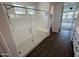 Clean bathroom featuring a modern glass shower and tile, as well as a view to the bedroom at 6947 W Spur Dr, Peoria, AZ 85383