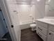 Bathroom featuring shower-tub combo, vanity with white cabinets, and tile flooring at 6947 W Spur Dr, Peoria, AZ 85383