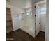 Bright bathroom featuring a glass-enclosed shower with bench seating and white tile at 6947 W Spur Dr, Peoria, AZ 85383