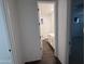 Bathroom view through doorway with tile flooring and white cabinets at 6947 W Spur Dr, Peoria, AZ 85383