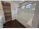 Bathroom features a walk-in glass shower with bench, next to a walk-in closet at 6947 W Spur Dr, Peoria, AZ 85383