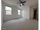 Spacious, carpeted bedroom with closet and ample light from dual windows, offering a cozy retreat at 6947 W Spur Dr, Peoria, AZ 85383