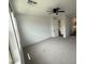Bedroom featuring neutral carpet, modern ceiling fan, and view to hallway at 6947 W Spur Dr, Peoria, AZ 85383