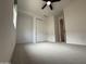 Bright bedroom featuring neutral carpet and a closet with double doors at 6947 W Spur Dr, Peoria, AZ 85383