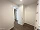 Small secondary bedroom with wood-look flooring, white walls, and doorway to bathroom at 6947 W Spur Dr, Peoria, AZ 85383