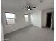 This bedroom features neutral walls, carpet, and a ceiling fan at 6947 W Spur Dr, Peoria, AZ 85383