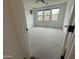 Large bedroom featuring bright, natural lighting, modern ceiling fan, and neutral carpet at 6947 W Spur Dr, Peoria, AZ 85383