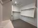 Walk-in closet with carpet and wooden clothes racks and shelving at 6947 W Spur Dr, Peoria, AZ 85383