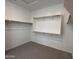 Walk-in closet with carpet and wooden clothes racks and shelving at 6947 W Spur Dr, Peoria, AZ 85383