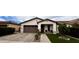 Charming single-story home with a well-manicured lawn, inviting entryway and a two car garage at 6947 W Spur Dr, Peoria, AZ 85383