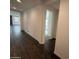 Hallway features hardwood flooring that connects the living spaces at 6947 W Spur Dr, Peoria, AZ 85383