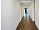 Inviting hallway features hardwood floors and neutral paint, leading to an open living space at 6947 W Spur Dr, Peoria, AZ 85383