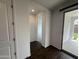 Hallway with dark wood flooring and backyard access offers a clean, modern design at 6947 W Spur Dr, Peoria, AZ 85383