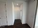 Hallway with dark wood flooring offers a clean, modern design and backyard access at 6947 W Spur Dr, Peoria, AZ 85383