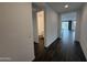 Hallway view to bathroom and living area with tile floors at 6947 W Spur Dr, Peoria, AZ 85383