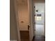 Hallway leading to laundry area and bedroom with ceiling fan at 6947 W Spur Dr, Peoria, AZ 85383