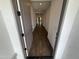 View of the home's interior featuring a hallway with hardwood flooring and neutral walls at 6947 W Spur Dr, Peoria, AZ 85383
