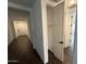 Hallway with an open closet and wood-look tile flooring at 6947 W Spur Dr, Peoria, AZ 85383