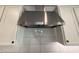 Sleek stainless steel kitchen hood with stylish white cabinets and subway tile backsplash at 6947 W Spur Dr, Peoria, AZ 85383