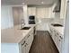 Gourmet kitchen features quartz countertops, stainless steel appliances, and white cabinetry at 6947 W Spur Dr, Peoria, AZ 85383