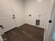 Laundry room with wood-look tile flooring and washer/dryer hookups at 6947 W Spur Dr, Peoria, AZ 85383