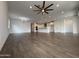 Open concept living space with wood look tile flooring, adjacent to kitchen at 6947 W Spur Dr, Peoria, AZ 85383