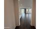 Open-concept living room with wood-look tile flooring and lots of natural light at 6947 W Spur Dr, Peoria, AZ 85383