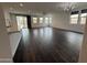 Bright living room with wood-look tile flooring and sliding glass doors to the backyard at 6947 W Spur Dr, Peoria, AZ 85383