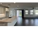 Open-concept living area with hardwood floors, natural light, and modern kitchen island at 6947 W Spur Dr, Peoria, AZ 85383