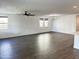 Bright living room with hardwood floors, stylish lighting, and multiple windows for natural light at 6947 W Spur Dr, Peoria, AZ 85383