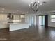 Bright and spacious living area featuring modern chandelier, open layout, and seamless flow at 6947 W Spur Dr, Peoria, AZ 85383