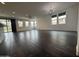 Living room with wood-look tile floors, many windows, and modern lighting at 6947 W Spur Dr, Peoria, AZ 85383