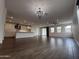 Spacious living room featuring hardwood floors, modern lighting, and an open floor plan at 6947 W Spur Dr, Peoria, AZ 85383